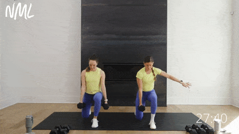 two women performing eccentric split lunges as part of lower body workout with dumbbells