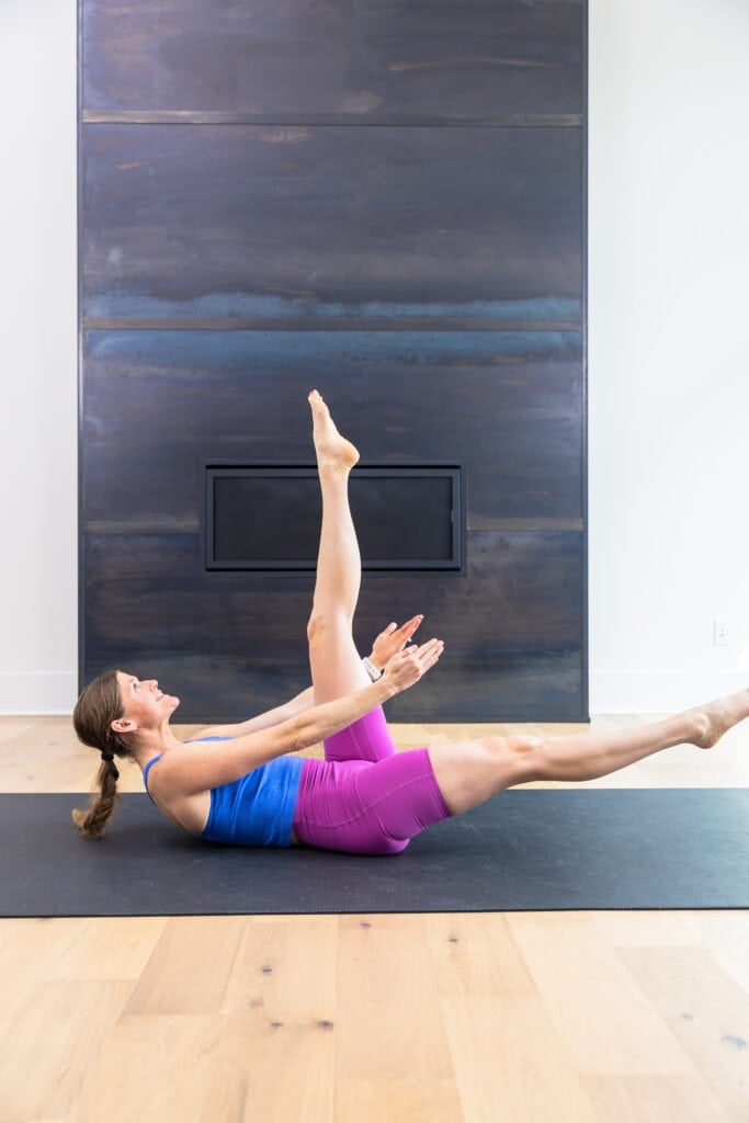 Woman performing leg lifts as part of ab challenge