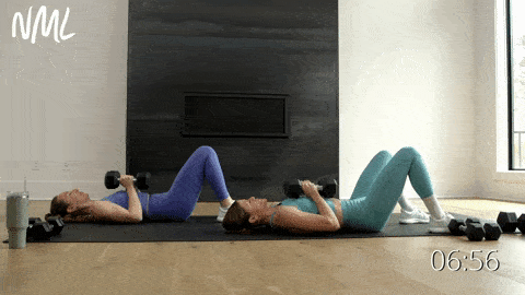 two women performing a diamond chest press in a chest workout at home