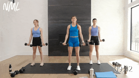three women performing a flip grip bicep curl with dumbbells in an upper body workout at home