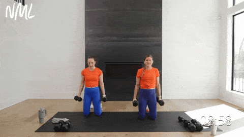 two women performing kneeling flip grip bicep curls in a back and bicep dumbbell workout