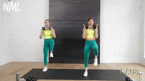 two women performing a lateral lunge and bicep curl and high knee switch in an endurance workout