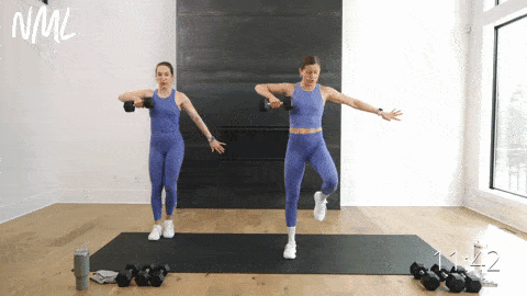 two women performing a lateral lunge and upright row with a dumbbell in a full body strength workout