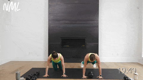 two women performing a push up and staggered burpee get up in a full body strength workout
