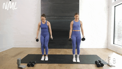 two women performing a reverse lunge hold and bicep curl in a strength workout with dumbbells