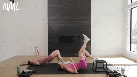 two women performing a single count glute bridge in a home leg workout for women