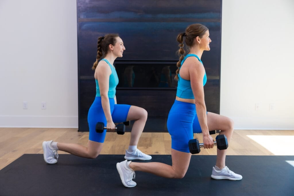 two women performing a split squat as example of eccentric leg exercise