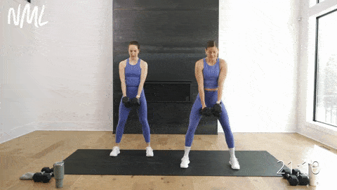 two women performing a squat and two back rows in a full body dumbbell workout