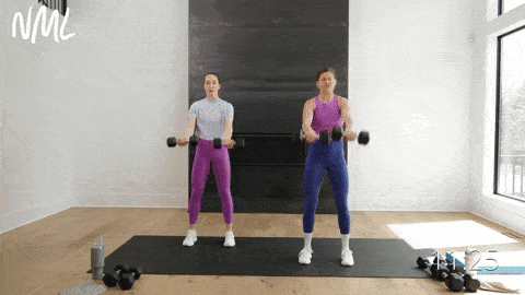 two women performing a standing chest fly and front raise with dumbbells in a chest, shoulders and triceps workout at home