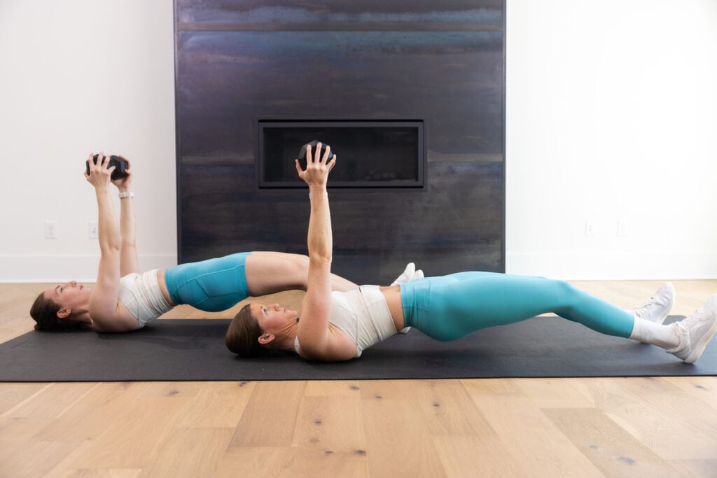 two women performing hamstring walk outs