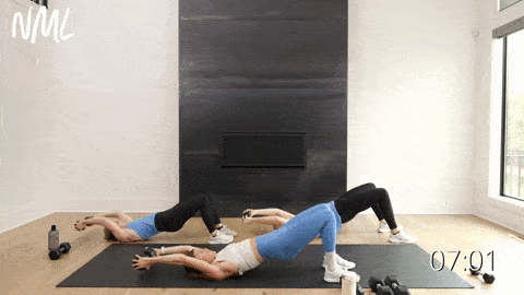 three women performing a glute bridge and dumbbell pullover