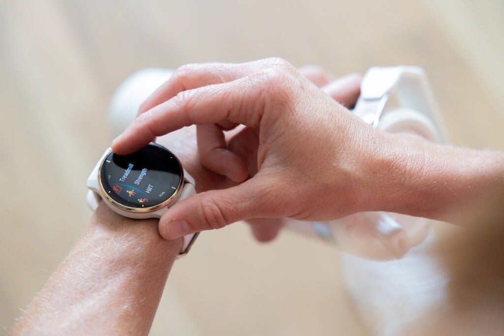 Woman wearing a Garmin Venu 2 Plus and choosing fitness to track. 