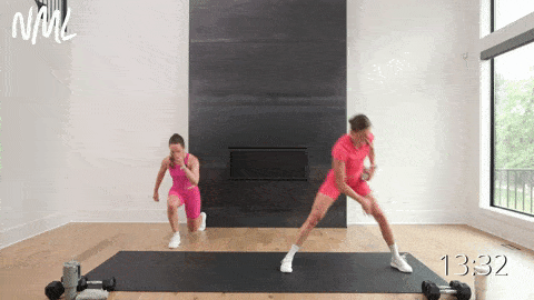 two women performing a lateral lunge and lunge jump switch in a HIIT workout