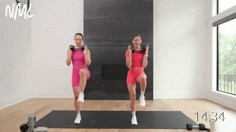 two women performing a reverse lunge press and tricep extension and high knee switch in a total body HIIT workout