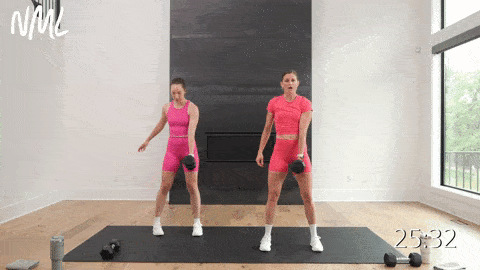 two women performing a squat pulse and handswitch and alternating snatch in a 30-minute HIIT workout 