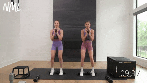 two women performing a heels elevated goblet squat as part of quad workout at home