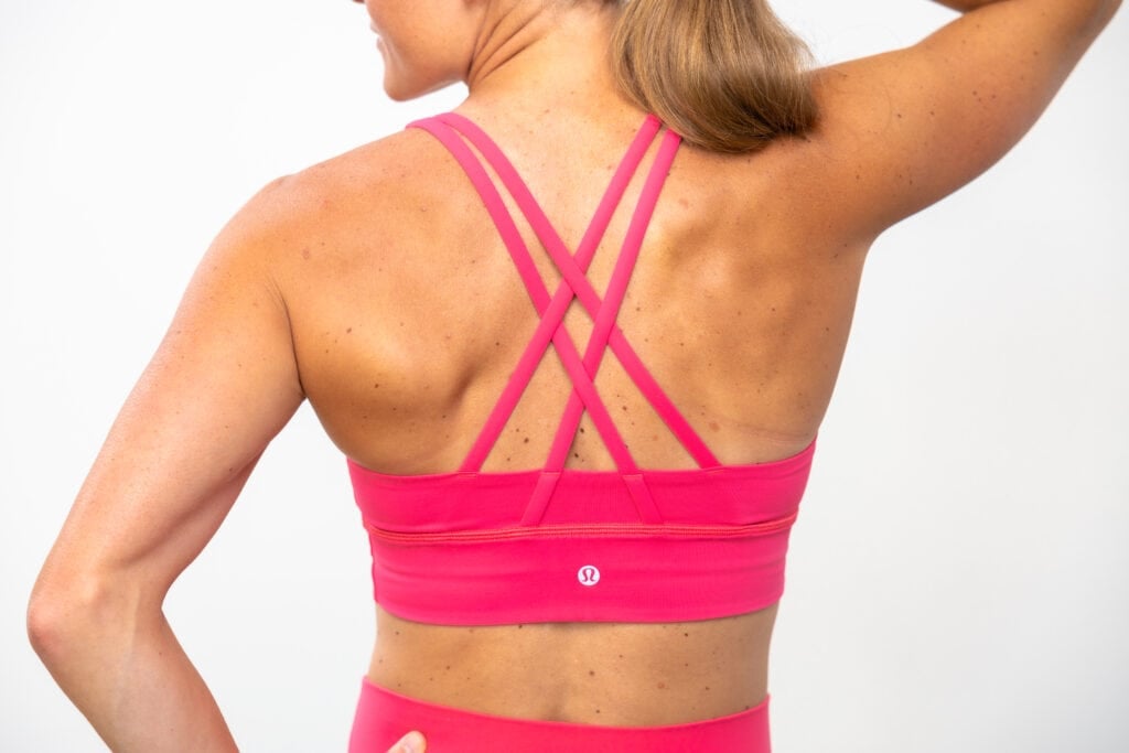 Woman showing back of energy bra as part of post sharing the best lululemon sports bras
