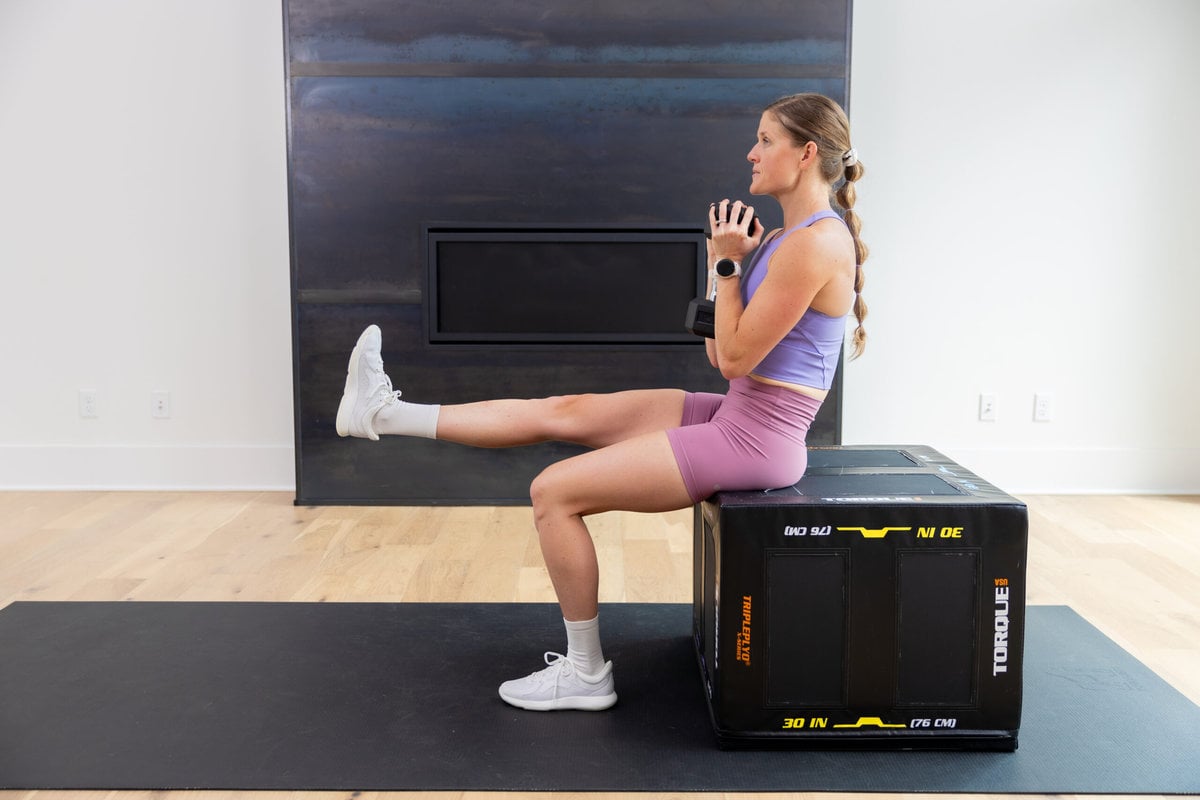 woman performing a single leg squat as example of quad exercises