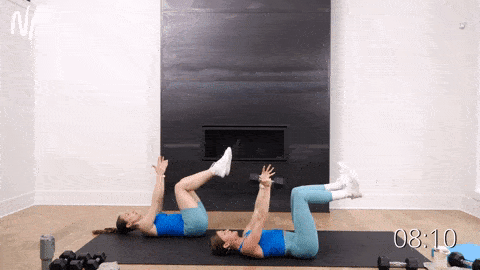 two women performing a single sided deadbug as part of unilateral core training workout 