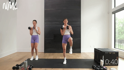 two women performing a lateral lunge and clean in a dumbbell leg workout