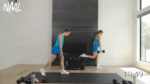 two women performing split squats in a lower body workout at home
