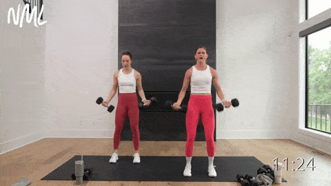 two women performing eccentric bicep curls to tone the upper arms with dumbbells in an arm workout