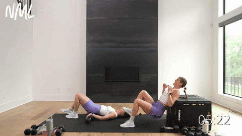 two women performing single leg hip thrusts or glute bridges in a dumbbell leg workout
