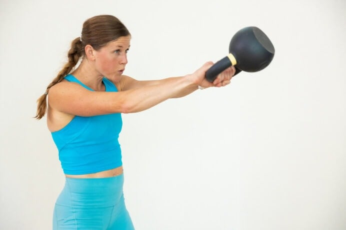 woman performing a kettlebell swing in a kettlebell workout for women