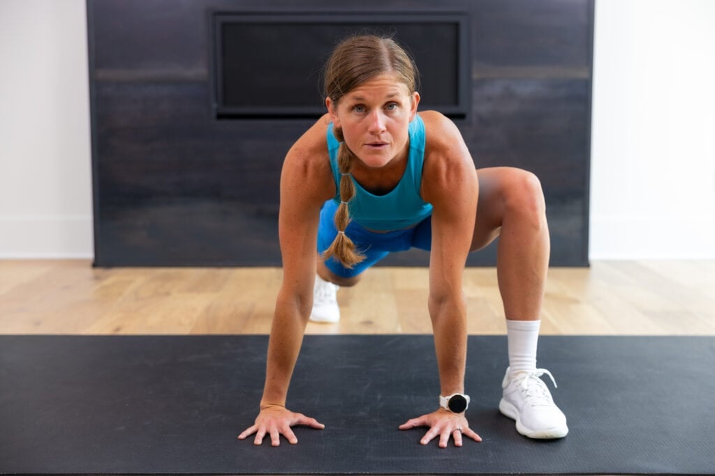 Woman performing a runner lunge or spider man steps as part of mobility workout