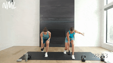two women performing a split lunge hold and single arm row in a kettlebell hiit workout for women