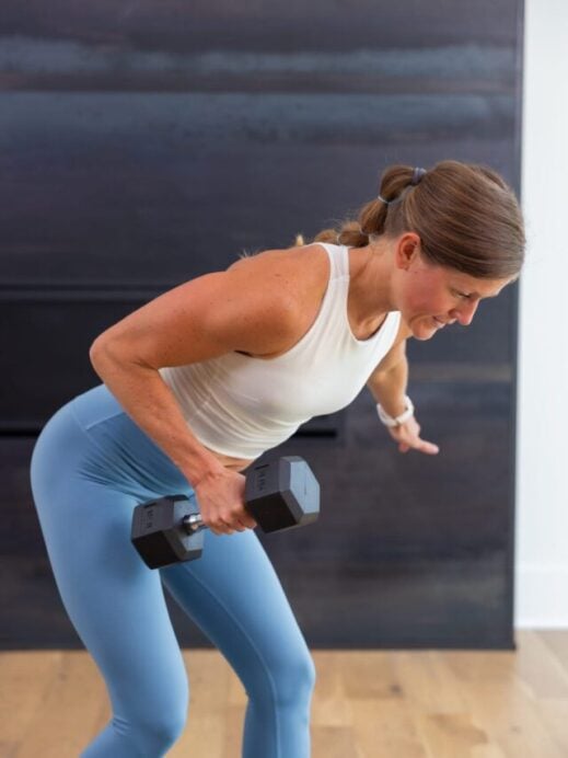 woman performing a single arm tricep kickback in a tricep workout