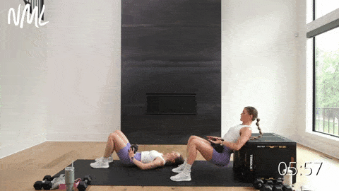 two women performing hip thrusts as example of dumbbell leg exercises