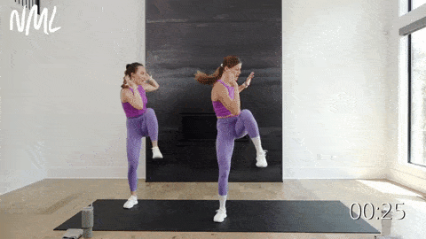 two women performing a lateral squat walk and standing crunch as part of at home cardio workout