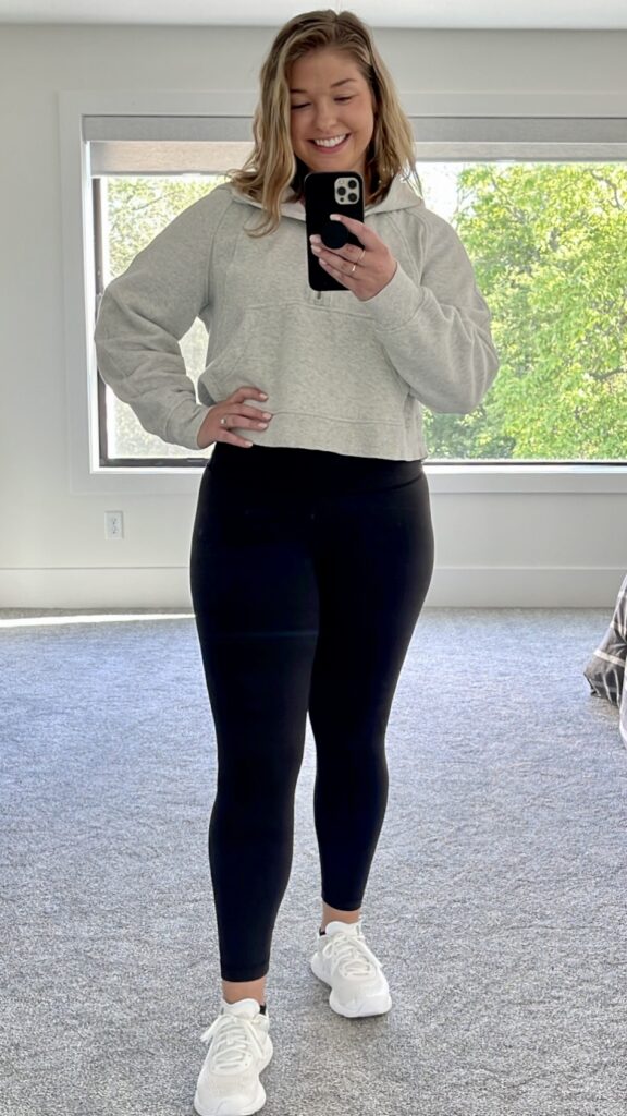 Woman wearing lululemon scuba sweatshirt posing in mirror as part of review of best lululemon sweatshirts