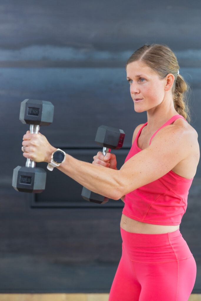 Woman performing a dumbbell punch as example of dumbbell shoulder exercises for women