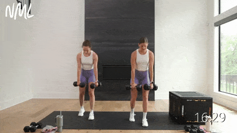 two women performing staggered deadlifts as part of dumbbell leg workout