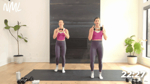 women performing a chair pose squat as part of yoga sculpt class