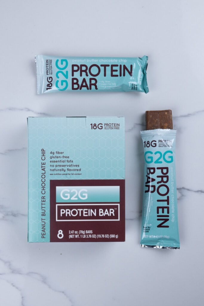 Peanut butter chocolate chip protein bars; box of protein bars, packaged protein bar and open bar.