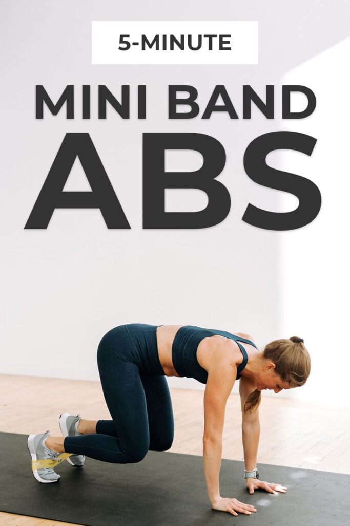 woman performing a bear crawl with a resistance band in an intense ab workout at home