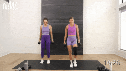 two women performing a standing bicep curl and shoulder press as example of best compound exercises