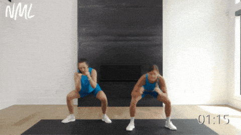 two women performing a standing ab exercise as part of ab circuit