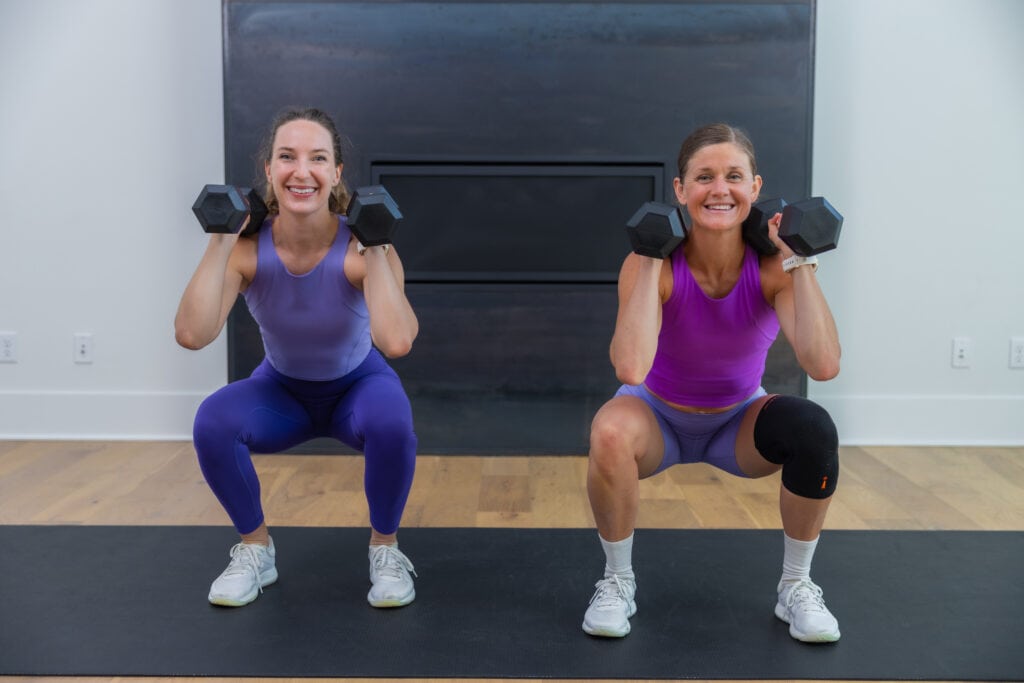 two women performing front squat as example of best compound exercises