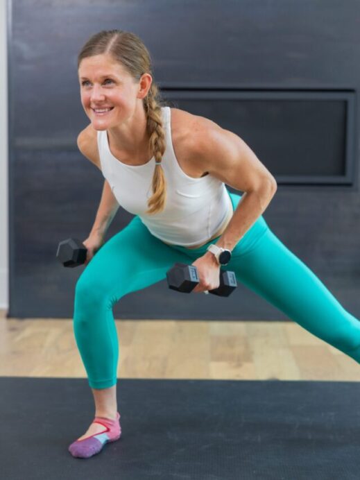 woman performing a lateral squat and back row in a barre sculpt workout