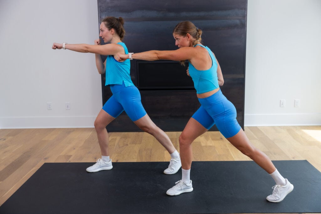 two women performing a crossbody punch as part of ab circuit workout