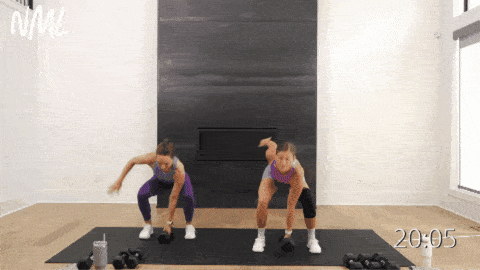 two women performing dumbbell snatches as example of compound exercises