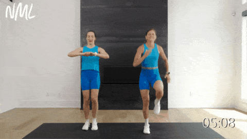 two women performing high knees as part of ab circuit workout