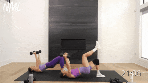 two women performing a single leg glute bridge and tricep extension as example of compound exercises