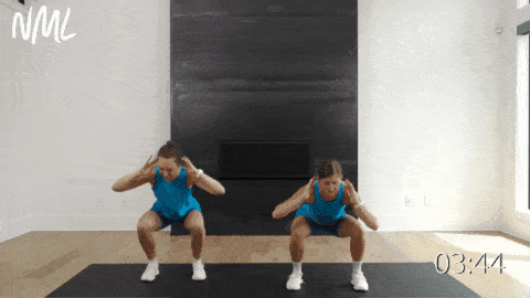 two women performing a squat and front toe tap as part of ab circuit workout