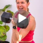 Woman doing a bicep curl hold with a play button in the center of the graphic