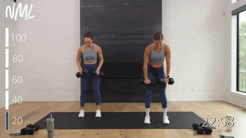 two women performing a dumbbell deadlift and clean as part of a total body workout